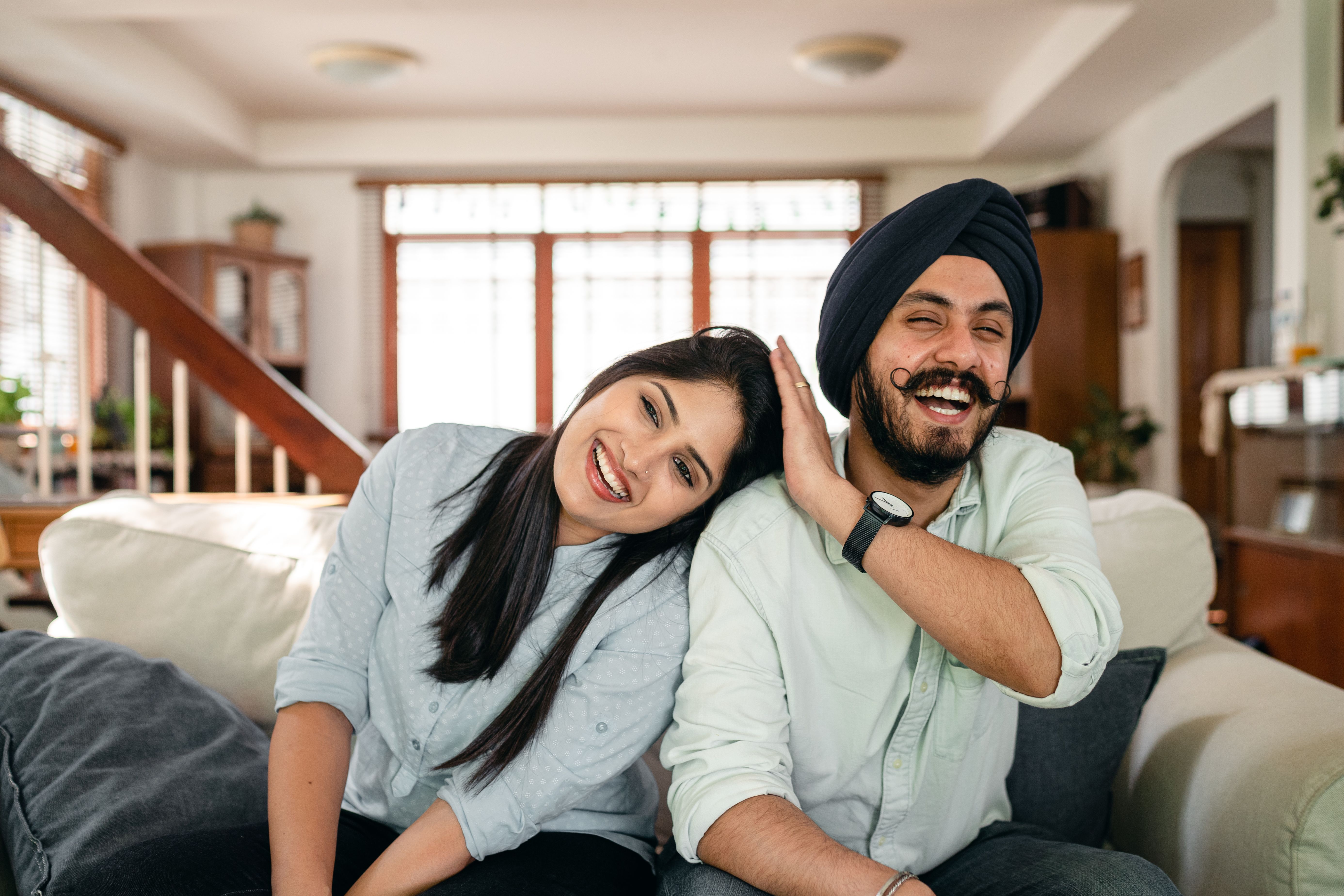 A couple laughing together at home